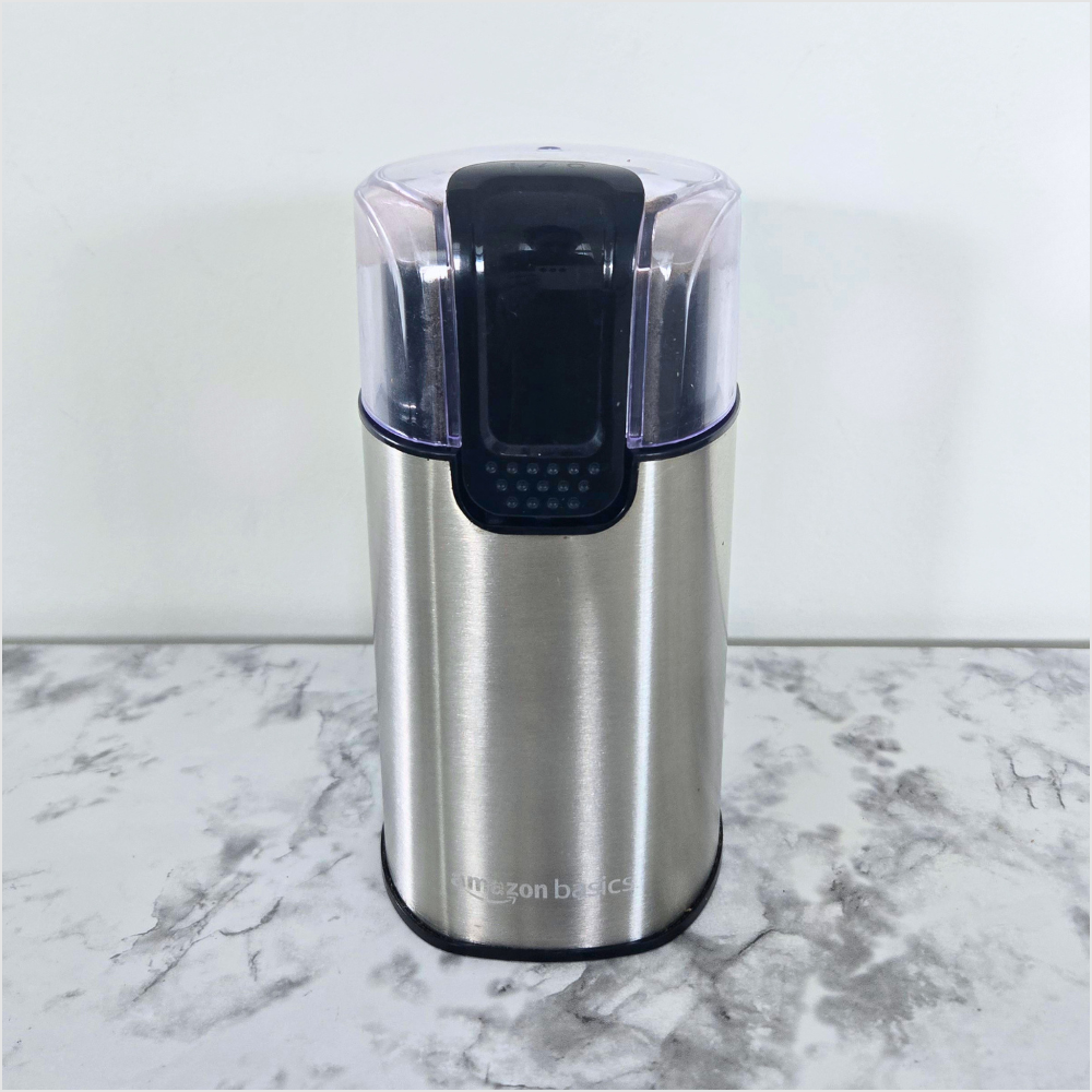 Amazon Basics electric coffee grinder with stainless steel blades for freshly grinding coffee beans and spices.