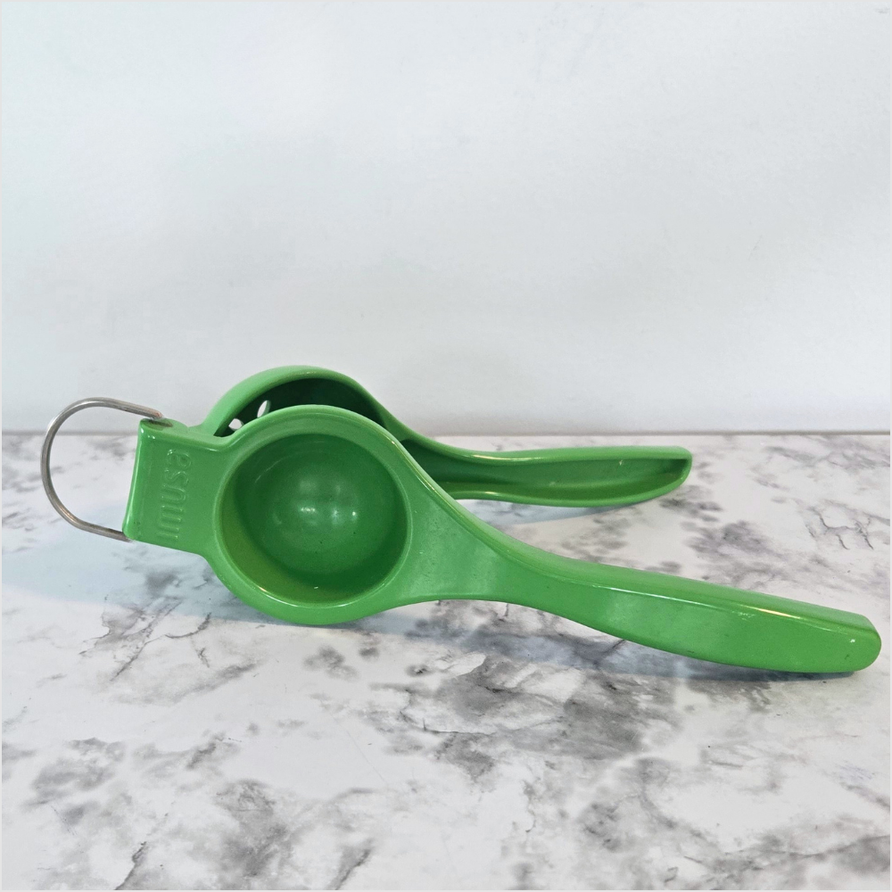 Green IMUSA manual citrus squeezer for fresh lemon and lime juice.