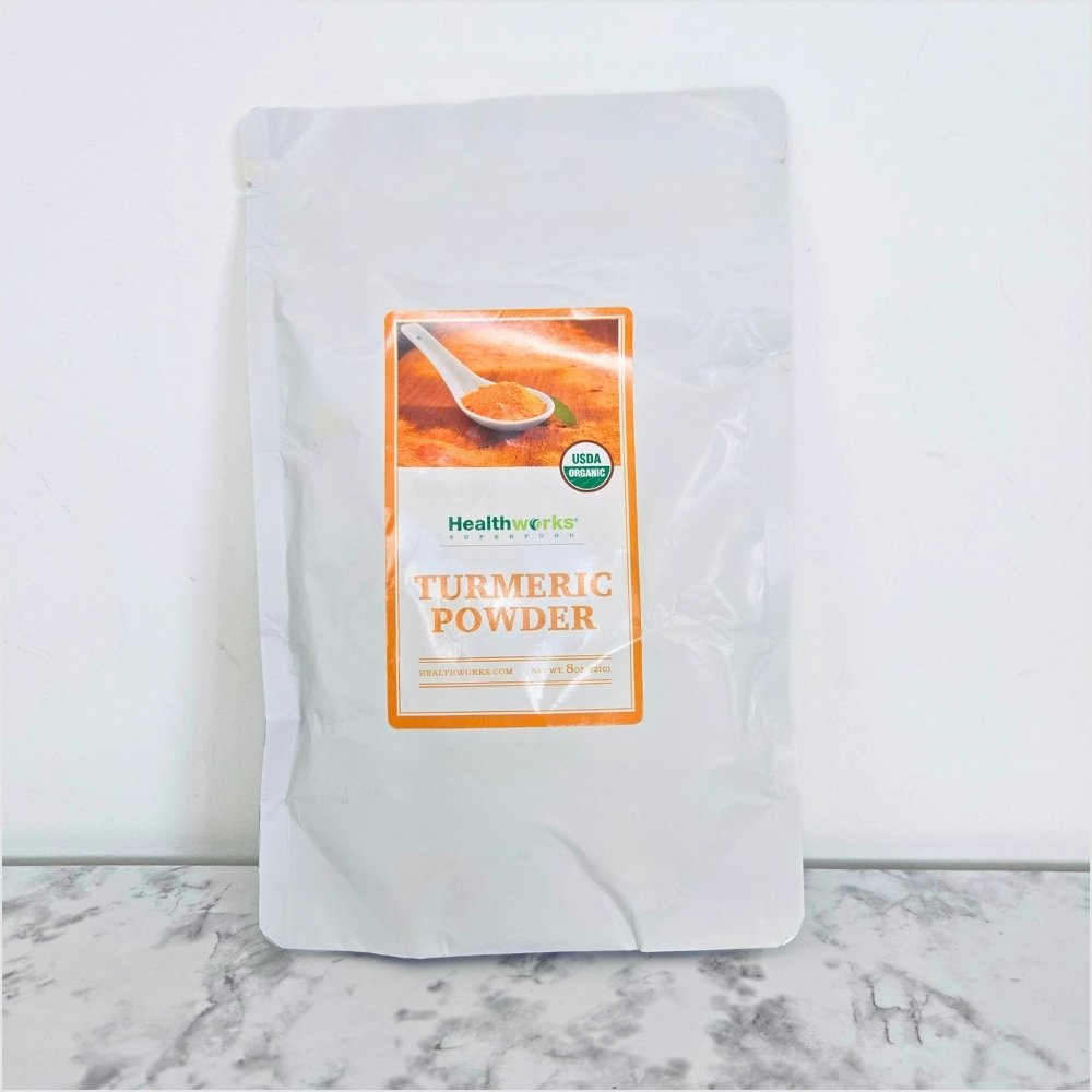 Healthworks Superfoods organic turmeric powder in an 8 ounce pouch, ground curcumin for adding warm, earthy flavor to food.